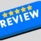 Blue button with five gold stars and the word 'Review' in bold white text